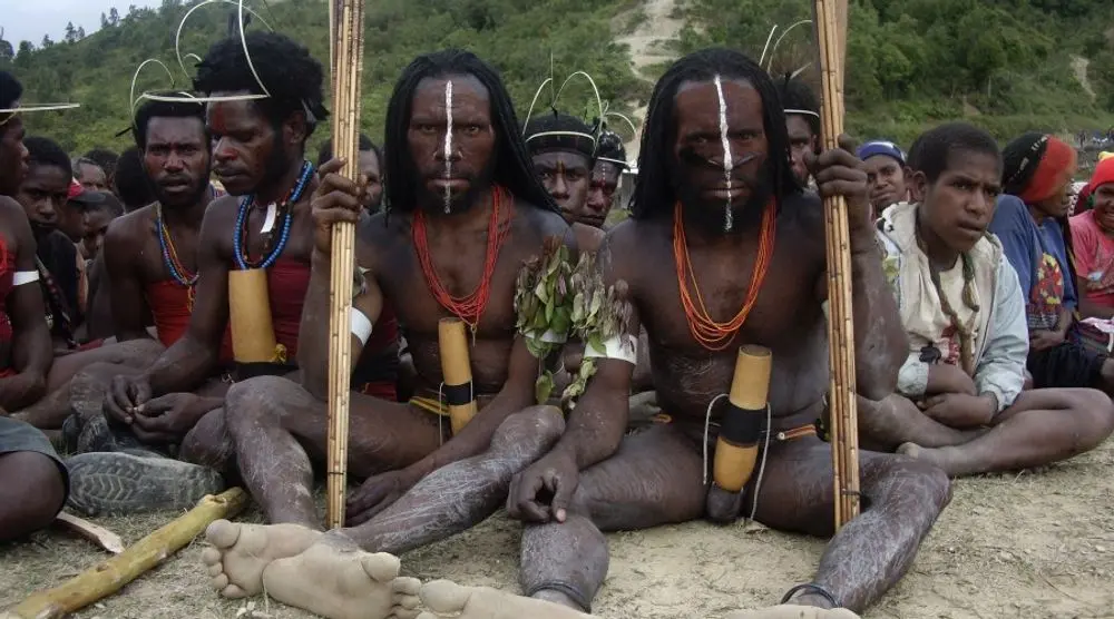 Papuan men with face paint and spears