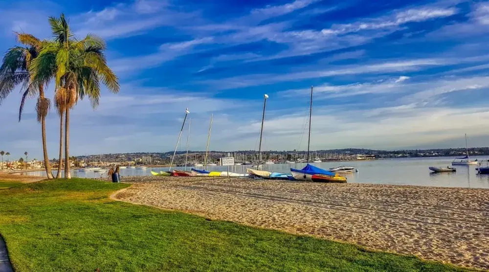 Sailboats and palms on a San Diego bay beach