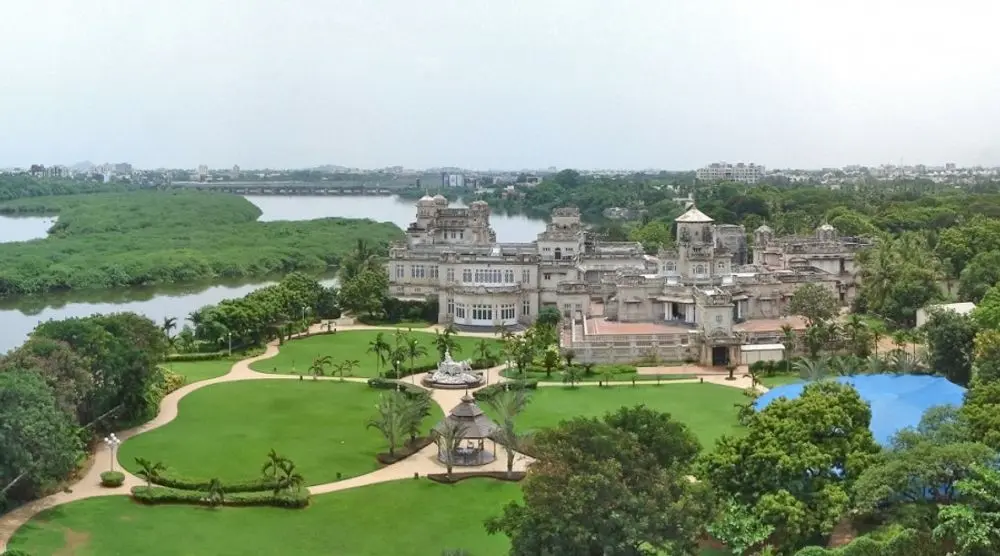 Aerial view of a grand mansion and gardens