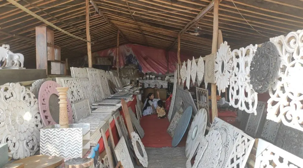 Carved white panels and mirrors at a stall