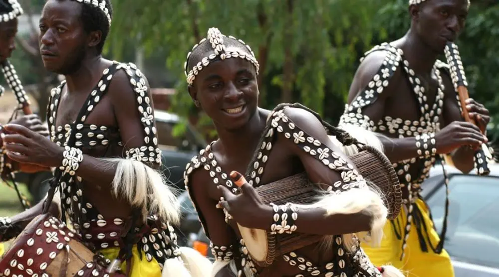 Dancers in cowrie-shell costumes
