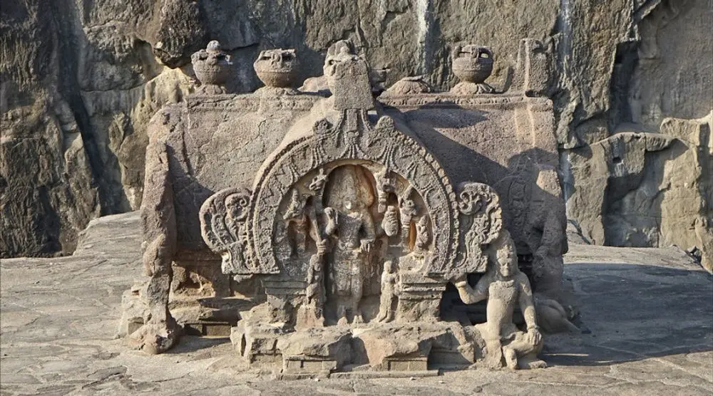 Carved stone shrine with a central deity
