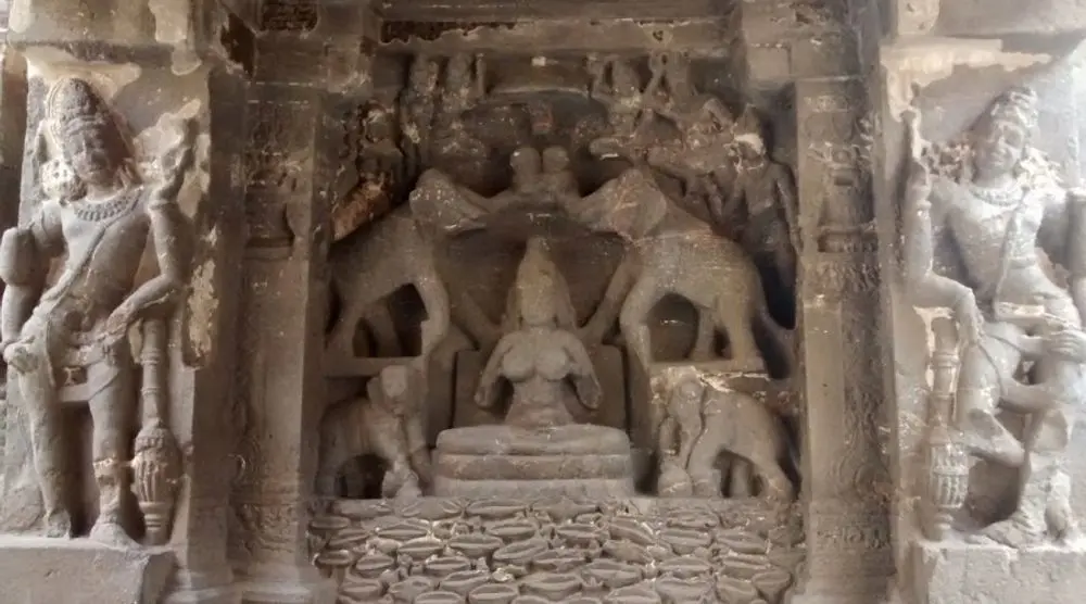 Carved stone panel of deities in a shrine