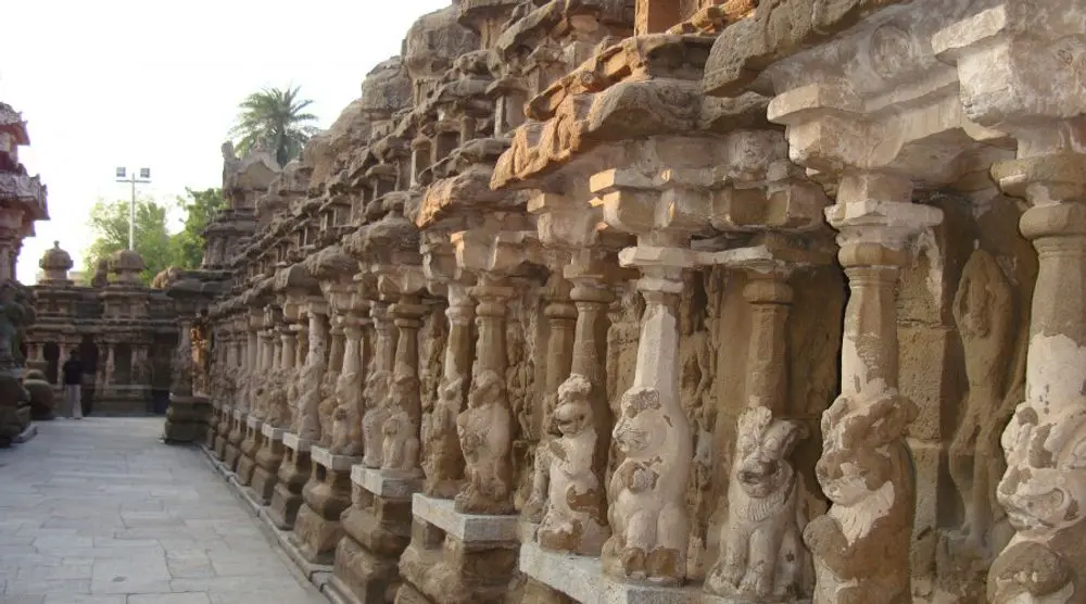 Row of carved shrines around a temple courtyard