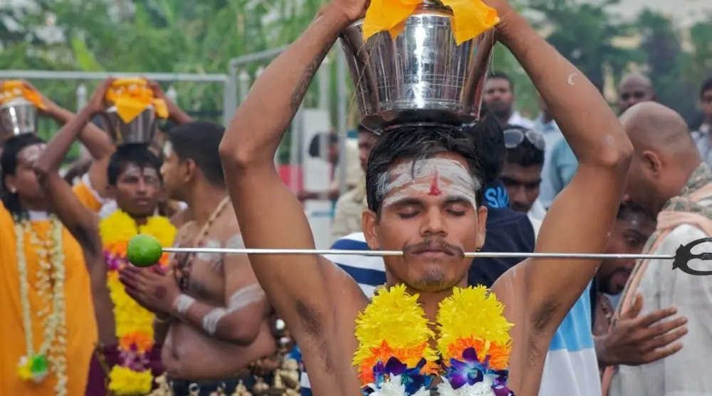 Devotee carrying a pot during a festival procession