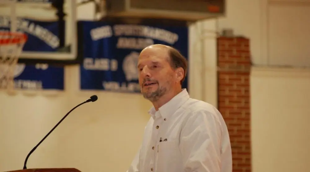 Man speaking at a lectern