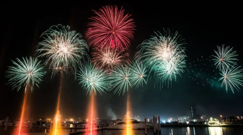 Fireworks over the water at night