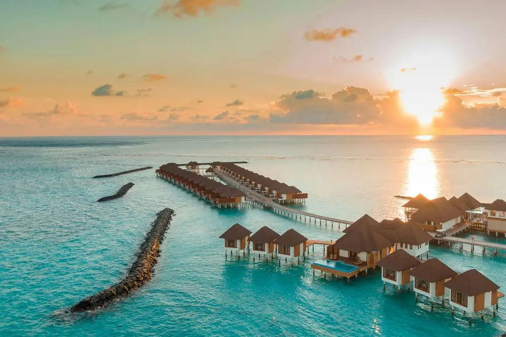 Overwater villas at sunset in the Maldives