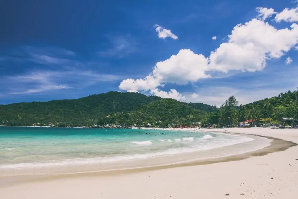 Curving white-sand beach with turquoise water
