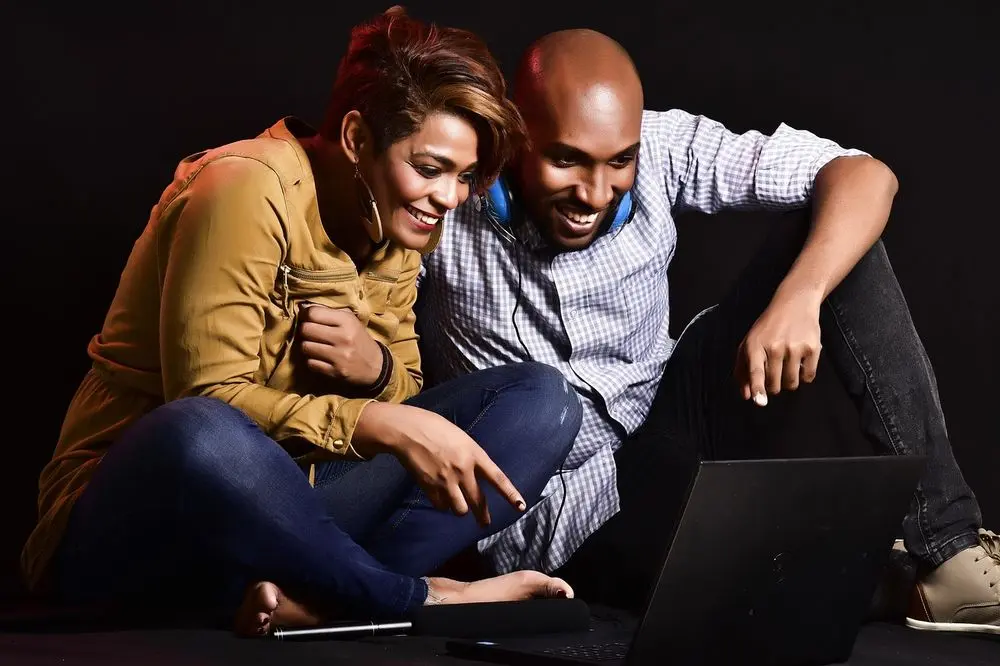 Couple planning a trip on a laptop