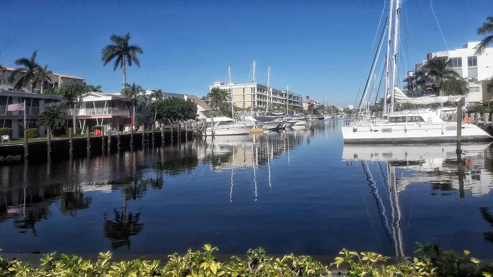 Yachts moored along a waterfront canal