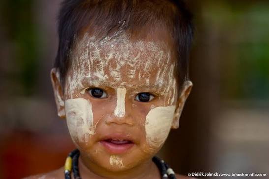 Child with thanaka paste on the face