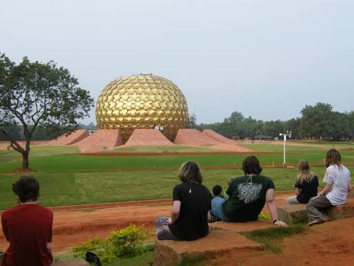 Visitors sitting before the Matrimandir, Auroville