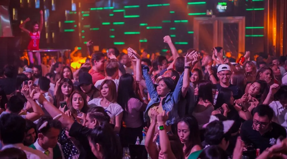 Crowd dancing at a packed nightclub