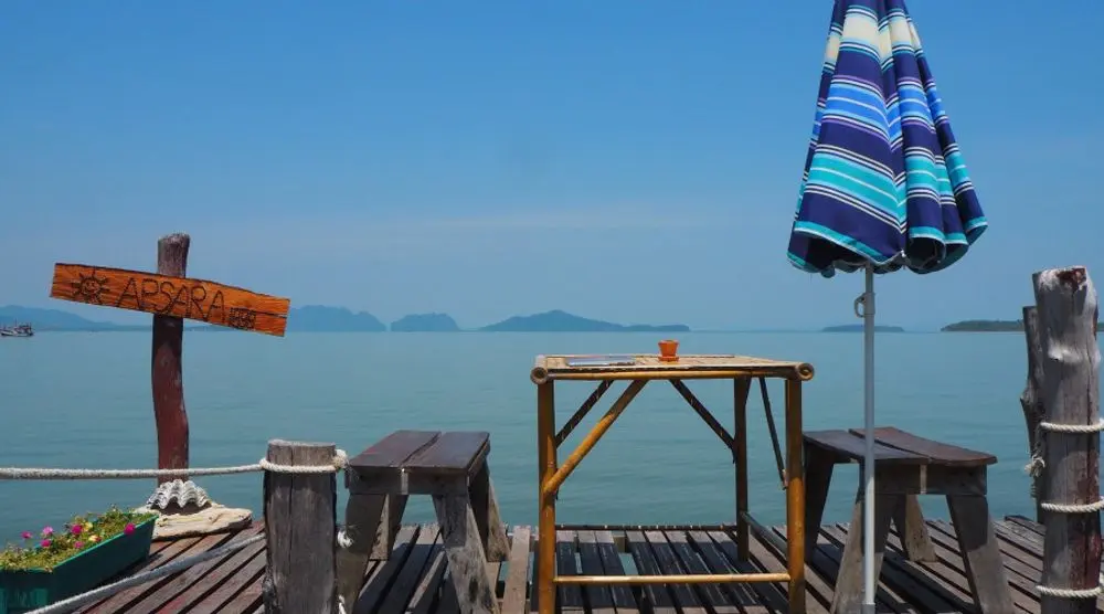 Seaside deck with tables and umbrellas