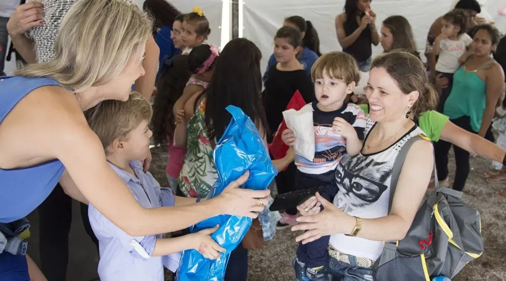 Volunteers handing out gifts to children