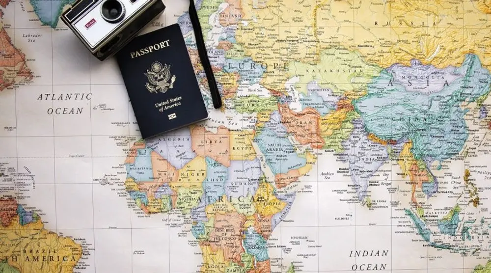 Passport, camera and world map