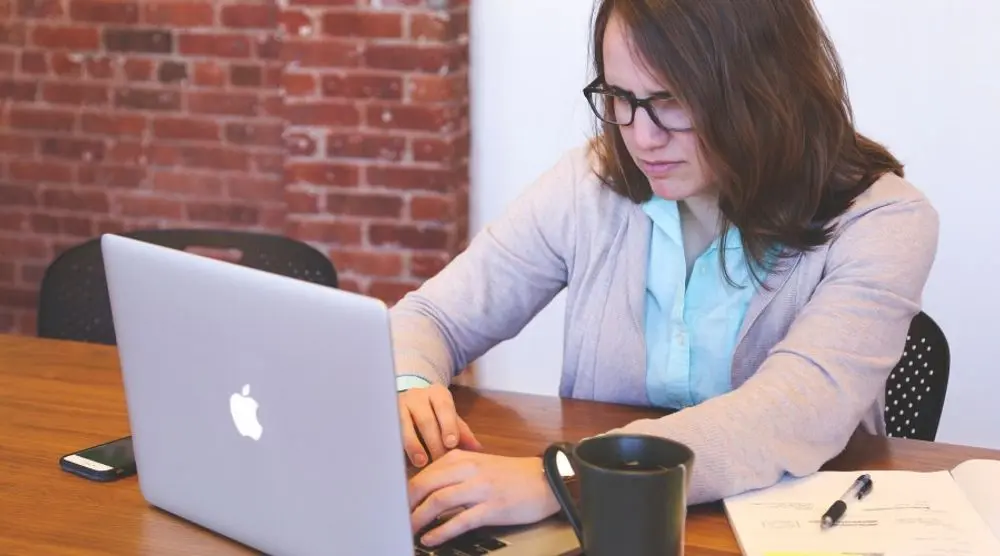 Woman working on a laptop at a desk