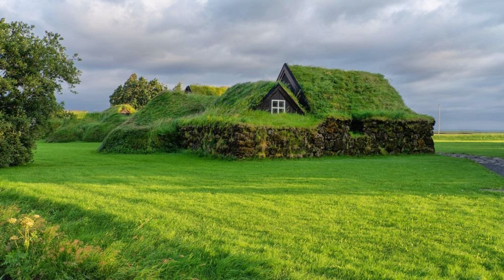 Turf-roofed eco house on a green meadow