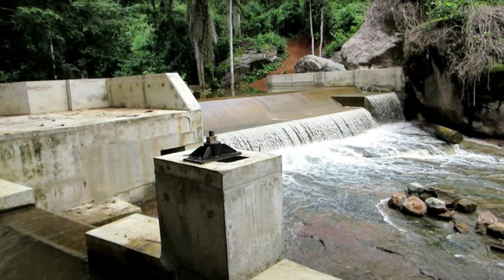 Small weir with water flowing over it