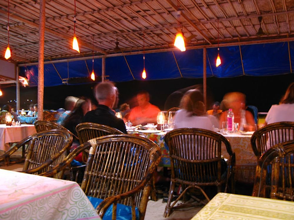 Diners at an outdoor restaurant at night