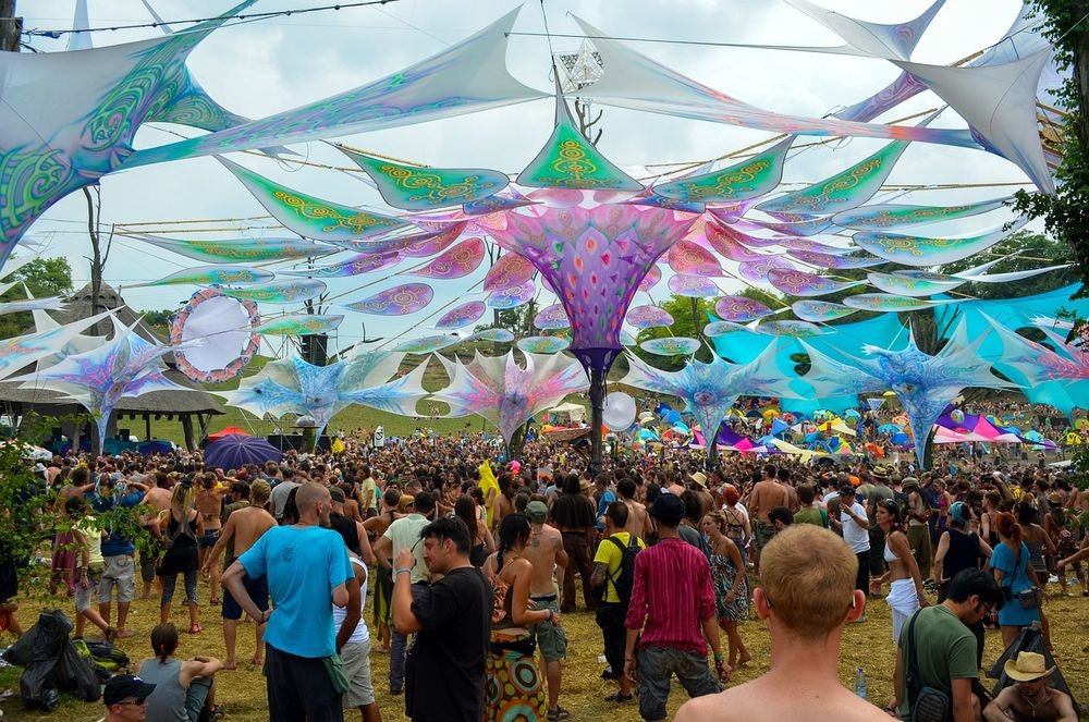 Crowd beneath colourful canopies at a Goa festival